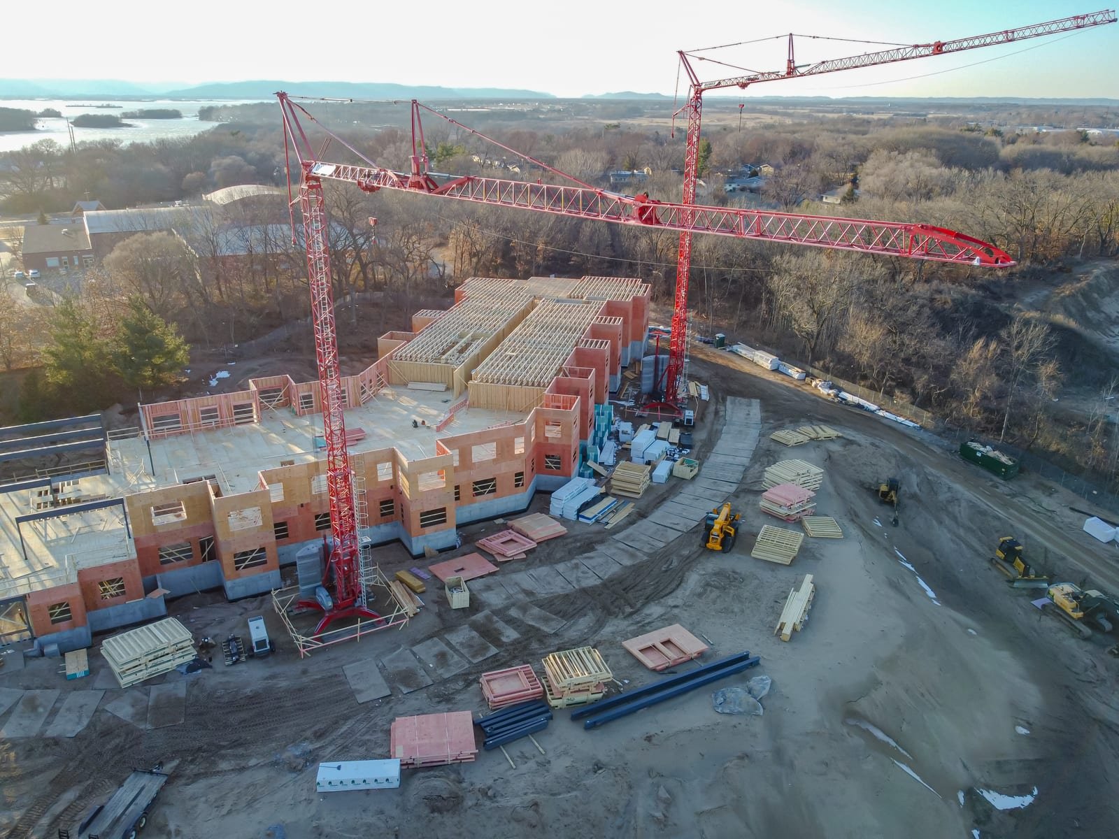 Illustrative image: aerial view of tower cranes over a building construction site.
